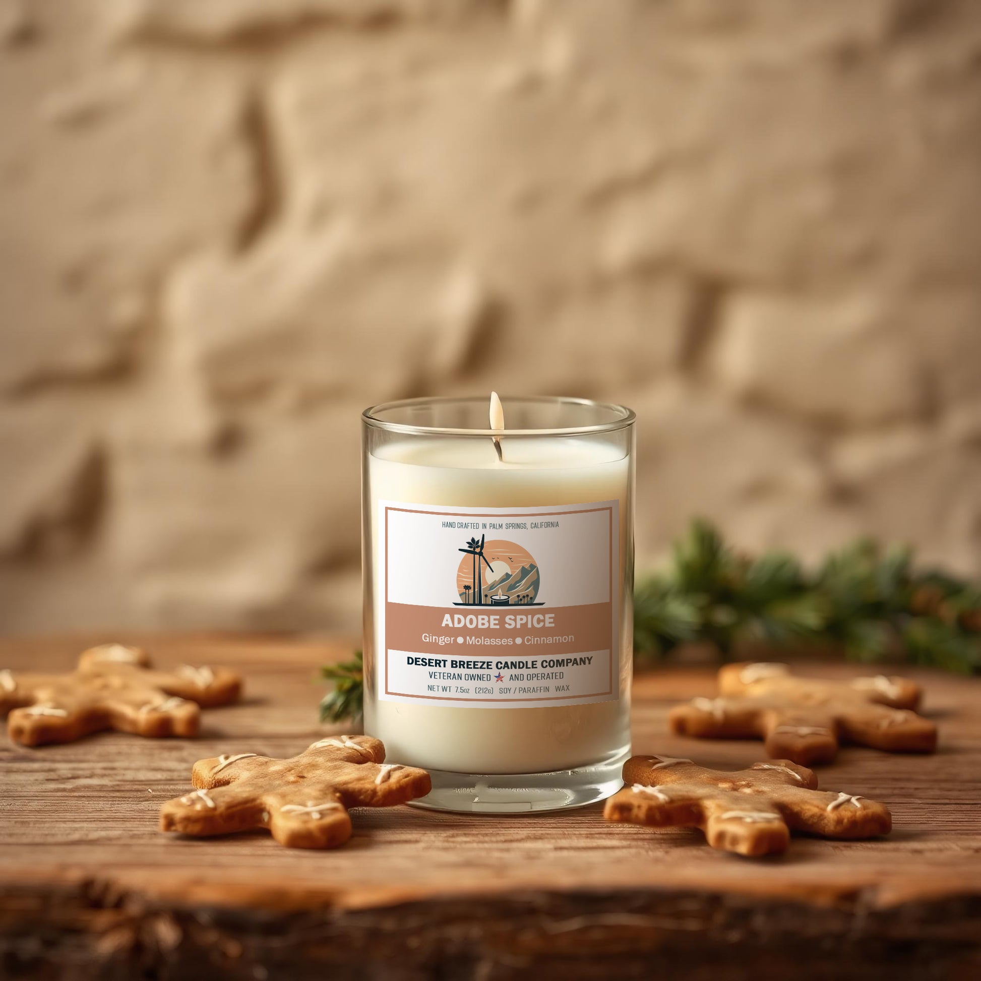 A Candle on a rough wood table with gingerbread cookies